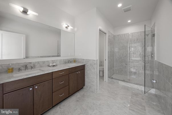 Bathroom, Dual Sink Vanities, Glass Shower, Interior, Marble, Marble Walls, Recessed Lighting