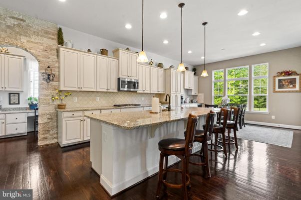 Interior, Kitchen, Pendant Lights, Recessed Lighting, Stainless Steel Appliances, Stone Walls, Wood Texture Flooring