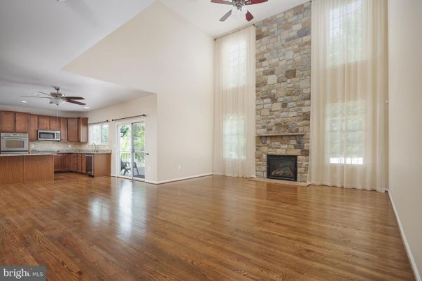Empty room, Fireplace, Interior, Kitchen, Recessed Lighting, Stone Walls, Wood Texture Flooring