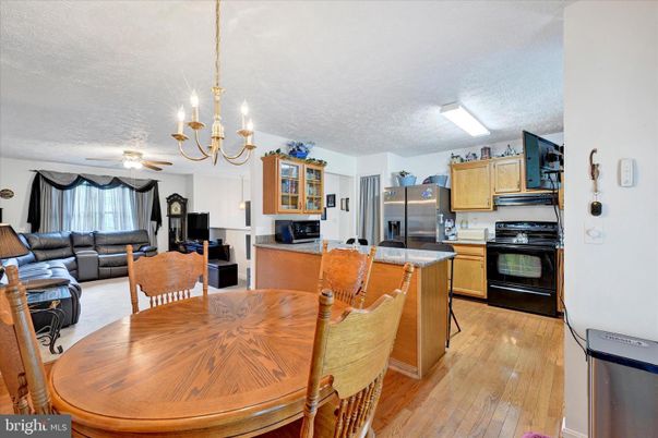 Chandelier, Dining room, Interior, Kitchen, Living room, Stainless Steel Appliances, Wood Texture Flooring
