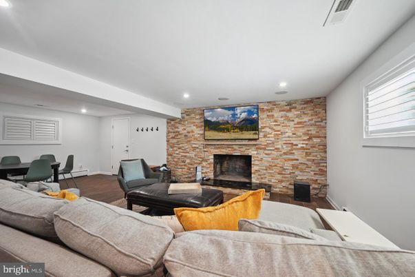 Dining room, Fireplace, Interior, Living room, Recessed Lighting, Stone Walls, Wood Texture Flooring