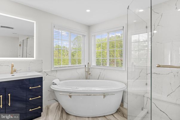 Bathroom, Free Standing Baths, Glass Shower, Interior, Marble Walls, Recessed Lighting, Wood Texture Flooring
