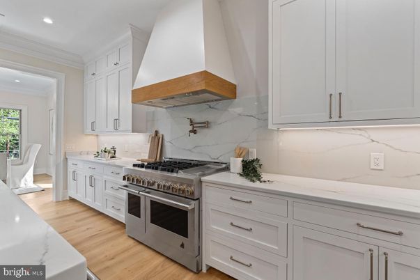 Interior, Kitchen, Marble Walls, Recessed Lighting, Stainless Steel Appliances, Wood Texture Flooring