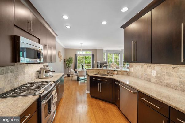 Chandelier, Dining room, Interior, Kitchen, Pendant Lights, Recessed Lighting, Stainless Steel Appliances, Wood Texture Flooring