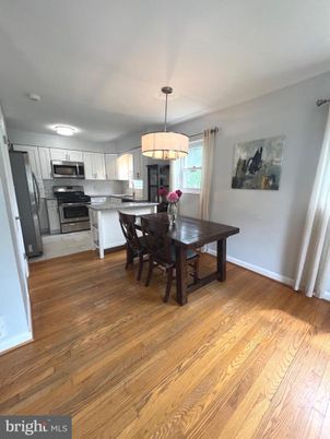 Chandelier, Dining room, Interior, Kitchen, Pendant Lights, Stainless Steel Appliances, Wood Texture Flooring