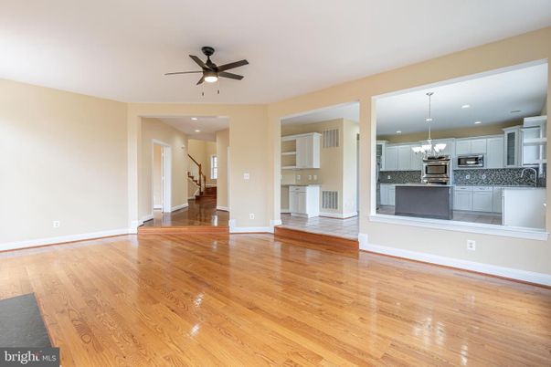 Chandelier, Empty room, Interior, Kitchen, Pendant Lights, Recessed Lighting, Stainless Steel Appliances, Wood Texture Flooring