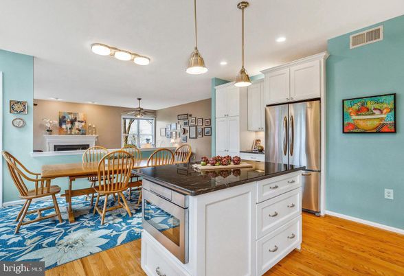 Dining room, Fireplace, Interior, Kitchen, Pendant Lights, Recessed Lighting, Stainless Steel Appliances, Wood Texture Flooring