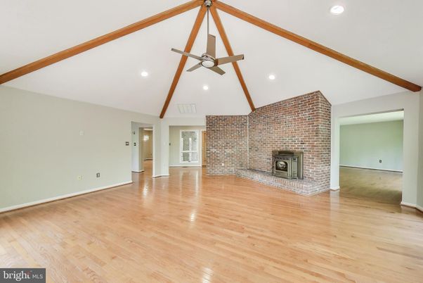 Empty room, Fireplace, Interior, Recessed Lighting, Stone Walls, Wooden Beams, Wood Texture Flooring