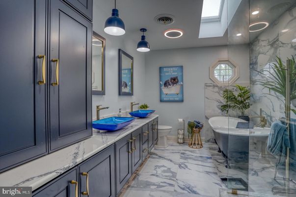 Bathroom, Dual Sink Vanities, Free Standing Baths, Interior, Marble, Marble Walls, Pendant Lights, Recessed Lighting