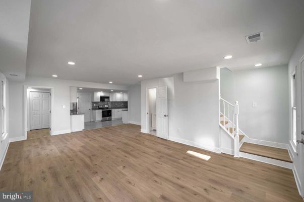 Empty room, Interior, Kitchen, Recessed Lighting, Stainless Steel Appliances, Wood Texture Flooring