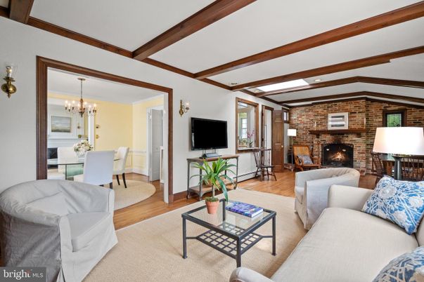 Chandelier, Dining room, Fireplace, Interior, Living room, Recessed Lighting, Stone Walls, Wooden Beams, Wood Texture Flooring