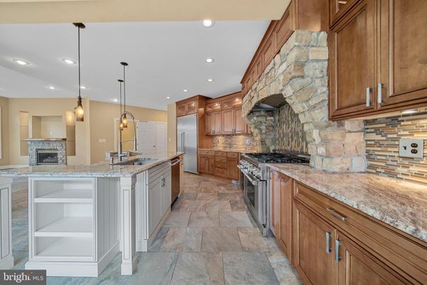 Fireplace, Interior, Kitchen, Pendant Lights, Recessed Lighting, Stainless Steel Appliances, Stone Walls