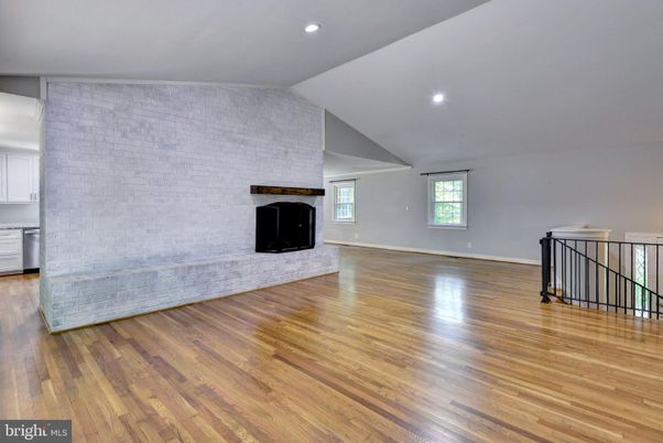 Empty room, Fireplace, Interior, Recessed Lighting, Stone Walls, Wood Texture Flooring