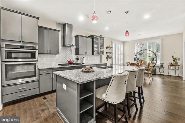 Chandelier, Dining room, Interior, Kitchen, Pendant Lights, Recessed Lighting, Stainless Steel Appliances, Wood Texture Flooring
