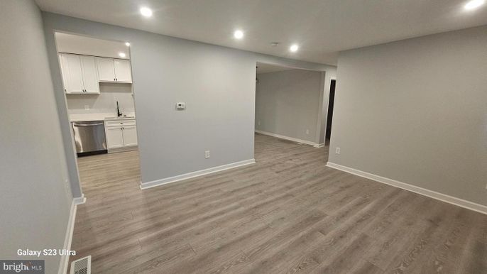 Empty room, Interior, Kitchen, Recessed Lighting, Stainless Steel Appliances, Wood Texture Flooring