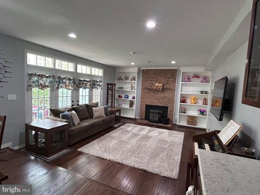 Fireplace, Interior, Living room, Recessed Lighting, Stone Walls, Wood Texture Flooring