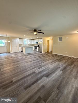 Empty room, Interior, Kitchen, Pendant Lights, Recessed Lighting, Stainless Steel Appliances, Wood Texture Flooring