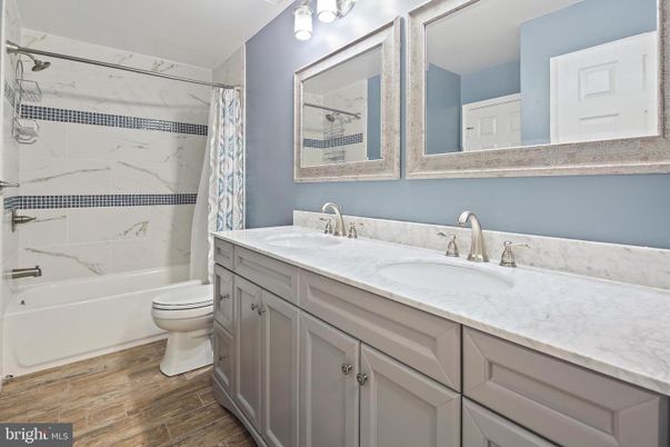 Bathroom, Dual Sink Vanities, Interior, Marble Walls, Wood Texture Flooring