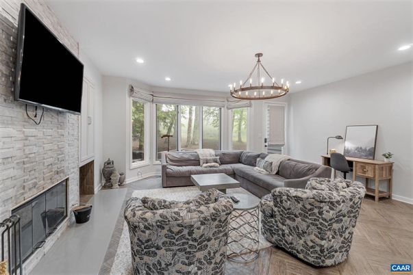 Chandelier, Fireplace, Interior, Living room, Recessed Lighting, Stone Walls, Wood Texture Flooring