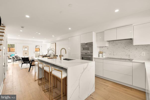 Interior, Kitchen, Marble Walls, Recessed Lighting, Stainless Steel Appliances, Wood Texture Flooring