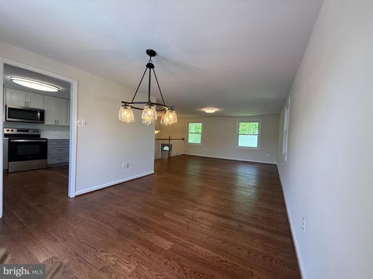Empty room, Interior, Kitchen, Pendant Lights, Stainless Steel Appliances, Wood Texture Flooring