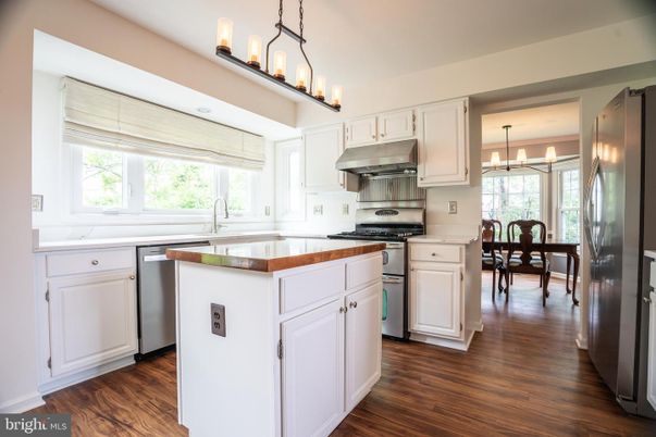 Chandelier, Dining room, Interior, Kitchen, Pendant Lights, Stainless Steel Appliances, Wood Texture Flooring
