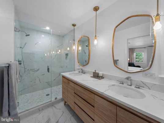 Bathroom, Dual Sink Vanities, Glass Shower, Interior, Marble, Marble Walls, Pendant Lights, Recessed Lighting