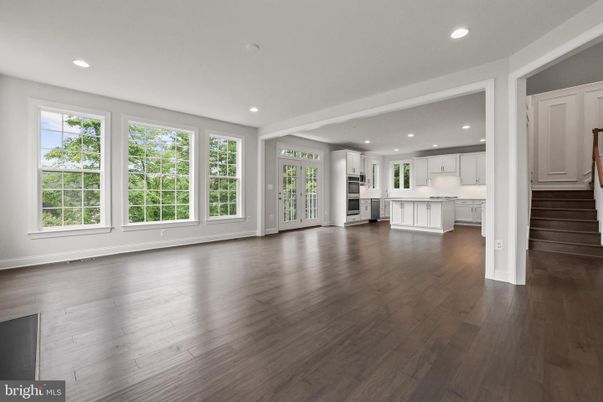 Empty room, Interior, Kitchen, Recessed Lighting, Stainless Steel Appliances, Wood Texture Flooring