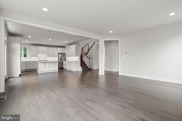 Empty room, Interior, Kitchen, Recessed Lighting, Stainless Steel Appliances, Wood Texture Flooring