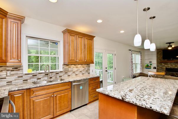 Fireplace, Interior, Kitchen, Pendant Lights, Recessed Lighting, Stainless Steel Appliances, Stone Walls