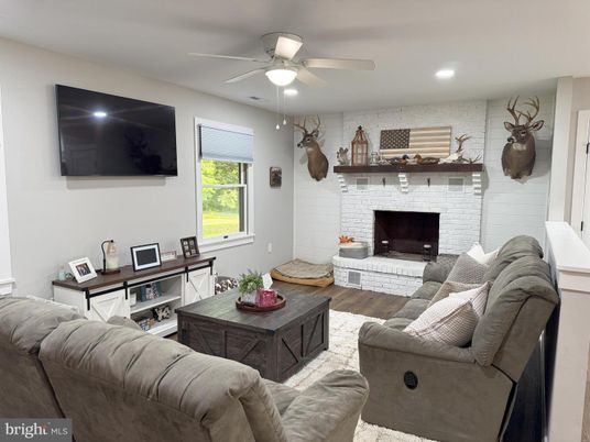 Fireplace, Interior, Living room, Recessed Lighting, Stone Walls, Wood Texture Flooring