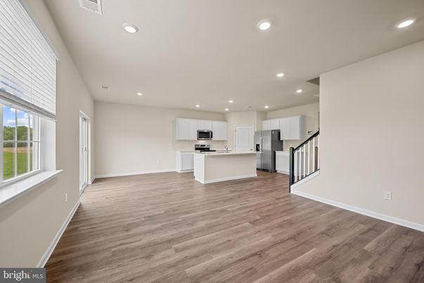 Empty room, Interior, Kitchen, Recessed Lighting, Stainless Steel Appliances, Wood Texture Flooring
