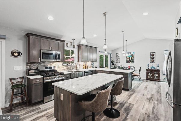Dining room, Interior, Kitchen, Pendant Lights, Recessed Lighting, Stainless Steel Appliances, Wood Texture Flooring