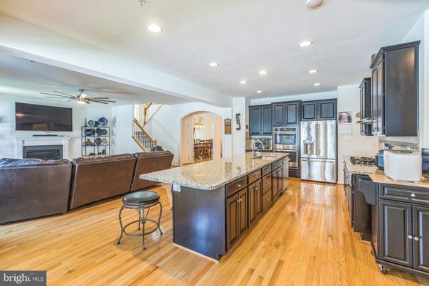 Fireplace, Interior, Kitchen, Living room, Recessed Lighting, Stainless Steel Appliances, Wood Texture Flooring