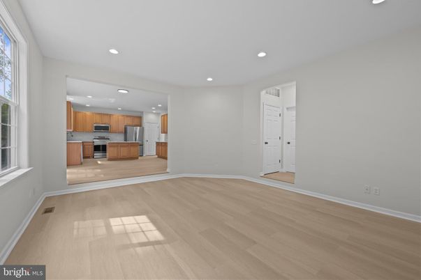 Empty room, Interior, Kitchen, Recessed Lighting, Stainless Steel Appliances, Wood Texture Flooring