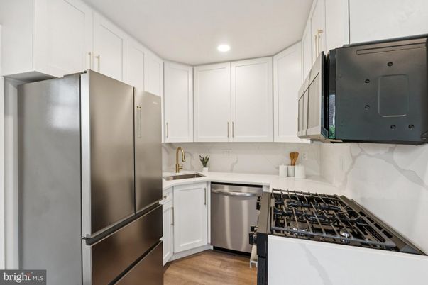 Interior, Kitchen, Marble Walls, Recessed Lighting, Stainless Steel Appliances, Wood Texture Flooring