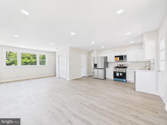Empty room, Interior, Kitchen, Recessed Lighting, Stainless Steel Appliances, Wood Texture Flooring