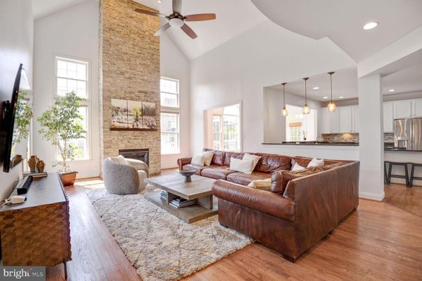 Fireplace, Interior, Kitchen, Living room, Pendant Lights, Recessed Lighting, Stainless Steel Appliances, Stone Walls, Wood Texture Flooring