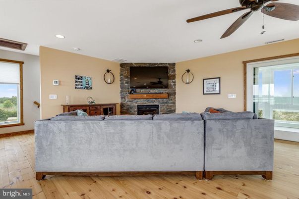 Fireplace, Interior, Living room, Recessed Lighting, Stone Walls, Wood Texture Flooring