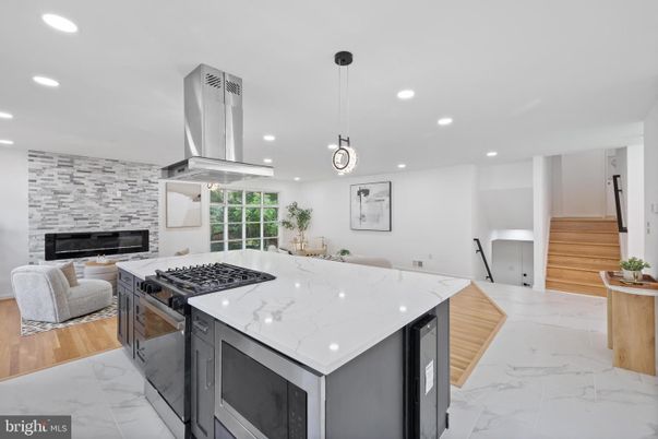 Fireplace, Interior, Kitchen, Living room, Marble, Pendant Lights, Recessed Lighting, Stainless Steel Appliances, Stone Walls