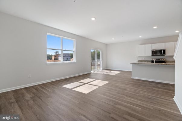 Empty room, Interior, Kitchen, Recessed Lighting, Stainless Steel Appliances, Wood Texture Flooring