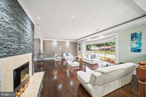 Dining room, Fireplace, Interior, Living room, Recessed Lighting, Stone Walls, Wood Texture Flooring