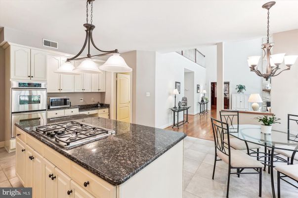 Chandelier, Dining room, Interior, Kitchen, Pendant Lights, Stainless Steel Appliances, Wood Texture Flooring