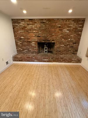 Empty room, Fireplace, Interior, Recessed Lighting, Stone Walls, Wood Texture Flooring