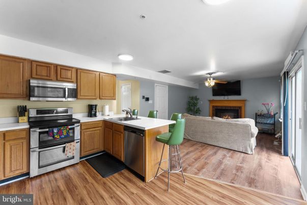 Fireplace, Interior, Kitchen, Living room, Recessed Lighting, Stainless Steel Appliances, Wood Texture Flooring