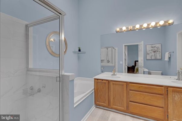 Bathroom, Dual Sink Vanities, Glass Shower, Interior, Marble Walls, Wood Texture Flooring