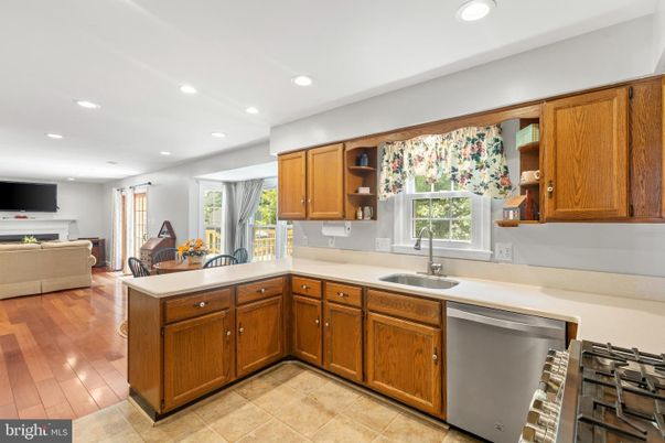 Fireplace, Interior, Kitchen, Recessed Lighting, Stainless Steel Appliances, Wood Texture Flooring
