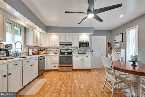 Dining room, Interior, Kitchen, Recessed Lighting, Stainless Steel Appliances, Wood Texture Flooring