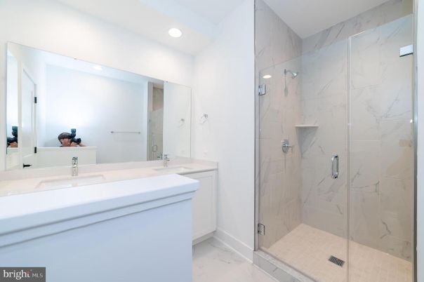 Bathroom, Dual Sink Vanities, Glass Shower, Interior, Marble, Marble Walls, Recessed Lighting