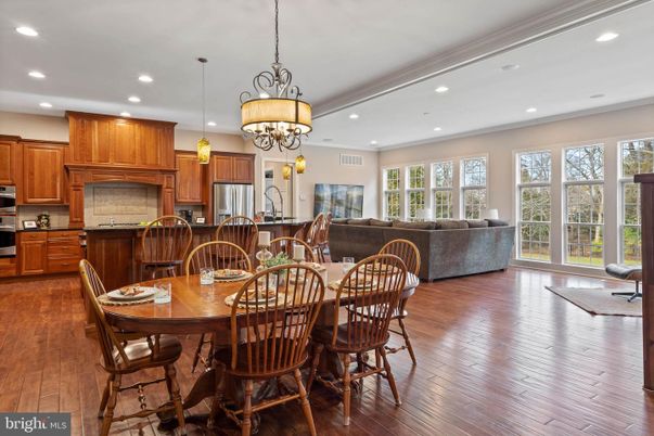 Chandelier, Dining room, Interior, Kitchen, Living room, Pendant Lights, Recessed Lighting, Stainless Steel Appliances, Wood Texture Flooring